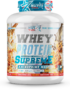 White whey protein tub with bold 'WHEY PROTEIN SUPREME' lettering and blue graphics, vanilla caramel flavor, 2 kg.
